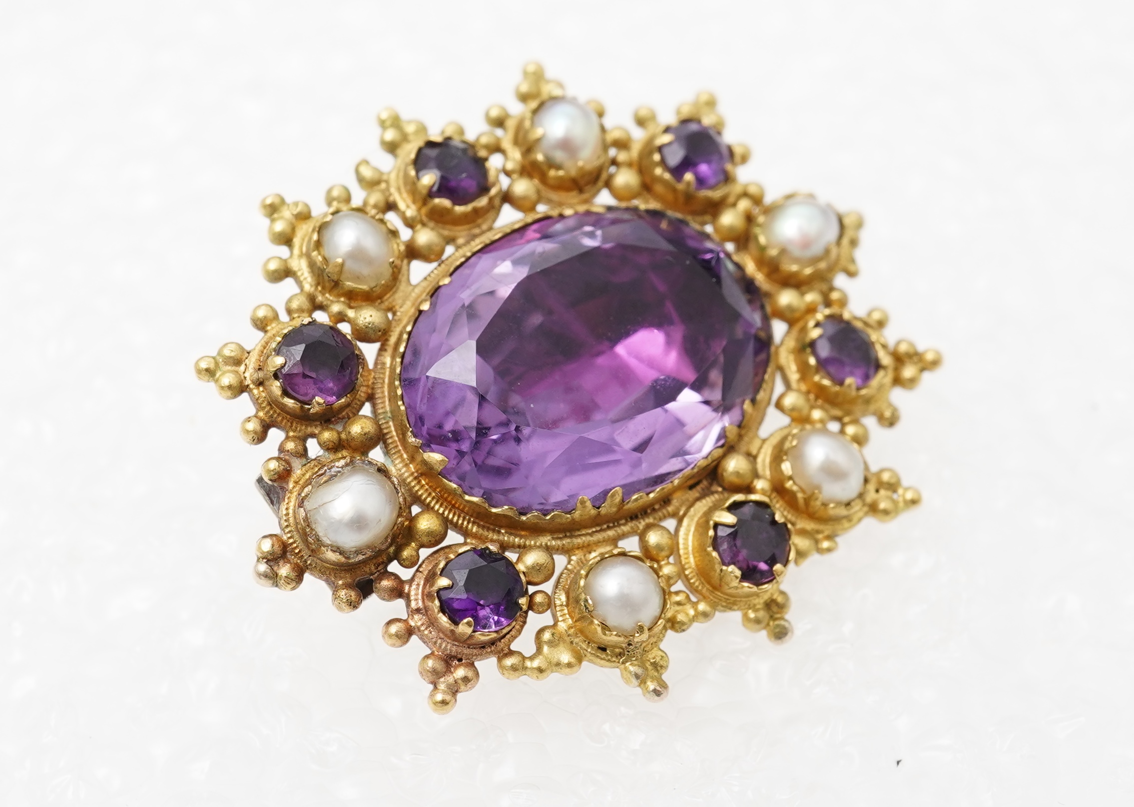An amethyst and split pearl brooch, mid 19th century